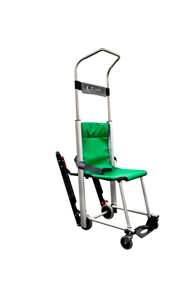 The Exitmaster Versa Evacuation Chair, an upright chair with a green seat, grey frame, and distinctive top handle, ready for emergency use.