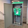 A grey Exitmaster Evacuation Chair Storage Cabinet with a transparent window or label area, designed to securely house an evacuation chair, against a white background.
