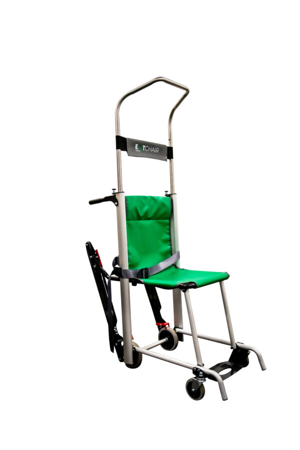 he Exitmaster Versa Plus Evacuation Chair, displaying its green seat, grey frame, four wheels, and distinctive extra mobility handles for enhanced maneuverability.